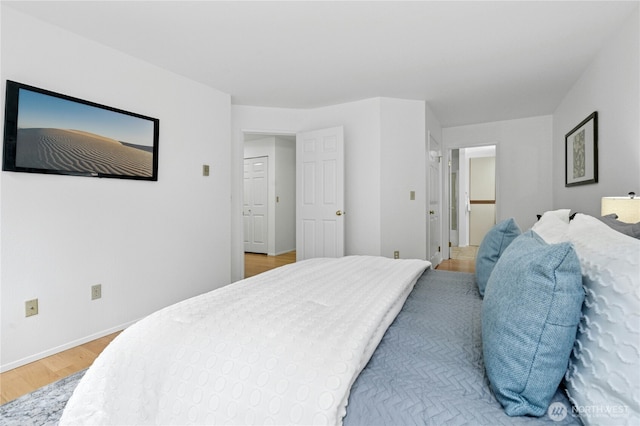 bedroom featuring baseboards and light wood-style floors