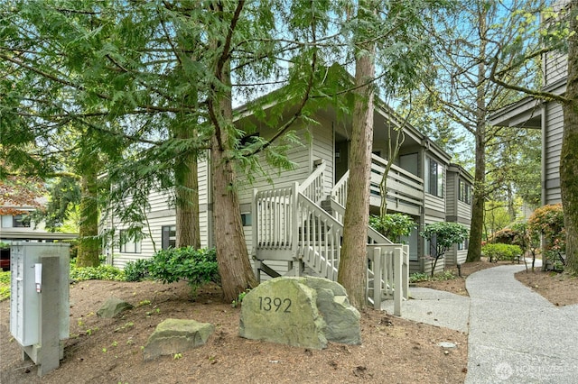 view of side of home featuring stairs