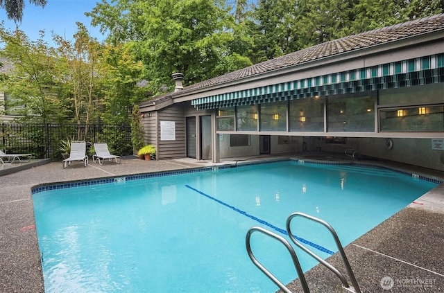 pool with fence and a patio area