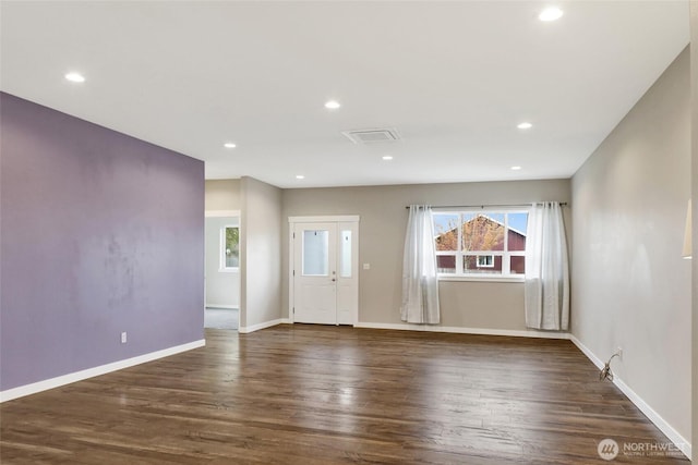 unfurnished living room with baseboards, visible vents, recessed lighting, and dark wood-type flooring