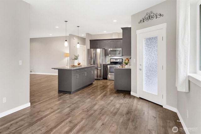 kitchen featuring baseboards, stainless steel appliances, and dark wood-type flooring