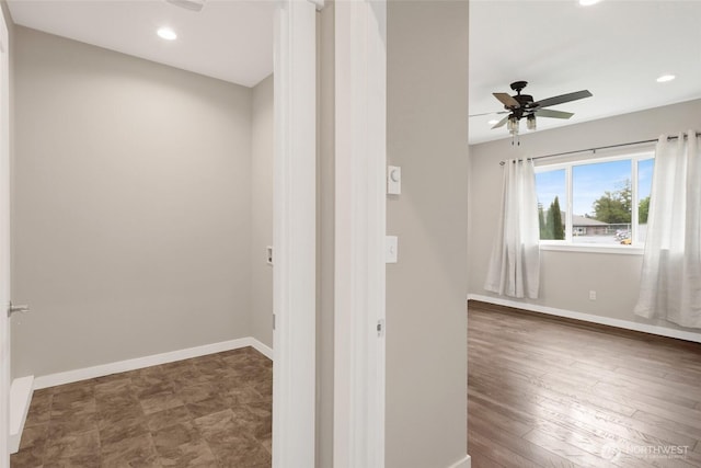 hallway with baseboards and recessed lighting