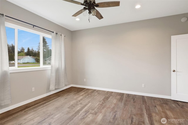 empty room with baseboards, a ceiling fan, wood finished floors, and recessed lighting