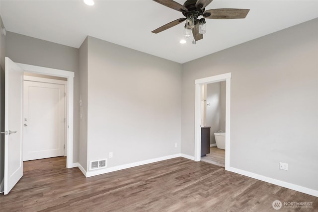 unfurnished bedroom featuring baseboards, recessed lighting, wood finished floors, and visible vents