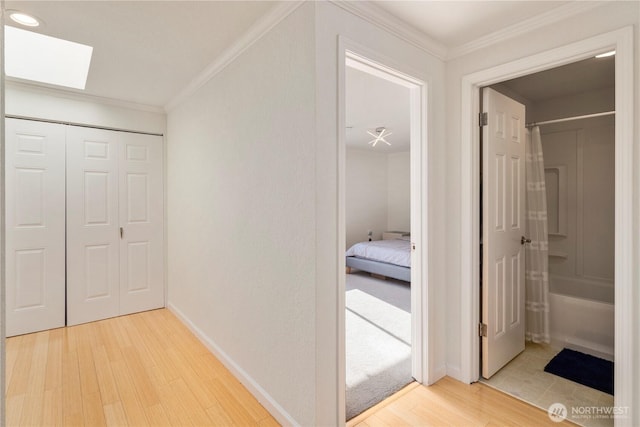2606 174th Ave NE, Redmond, WA 98052 - hall featuring baseboards, light wood-style flooring, crown molding, and a skylight