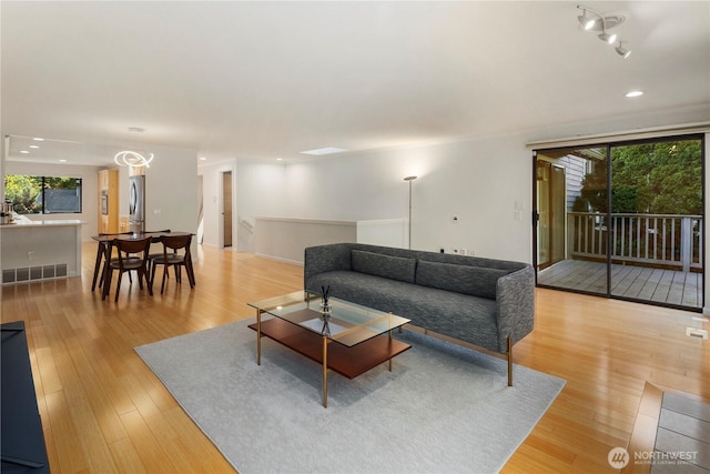2606 174th Ave NE, Redmond, WA 98052 - living room with visible vents, recessed lighting, light wood finished floors, and a wealth of natural light