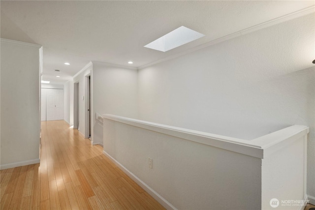 2606 174th Ave NE, Redmond, WA 98052 - hall featuring baseboards, light wood-style flooring, an upstairs landing, and a skylight