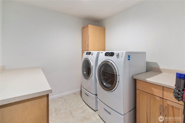 2606 174th Ave NE, Redmond, WA 98052 - washroom with baseboards, washing machine and dryer, and cabinet space