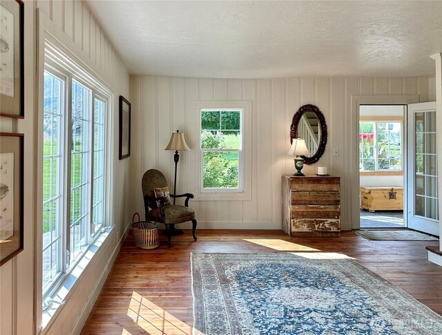 sitting room featuring a textured ceiling and wood finished floors