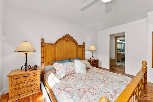 bedroom with baseboards, ceiling fan, and wood finished floors