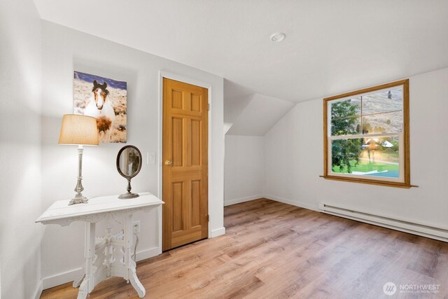 bonus room with baseboards, a baseboard radiator, wood finished floors, and lofted ceiling