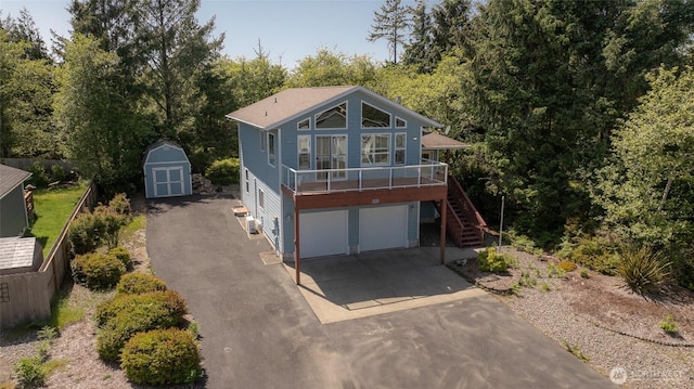 659 Chinook Ave SE, Ocean Shores, WA 98569 - view of front of house featuring stairs, an attached garage, and driveway