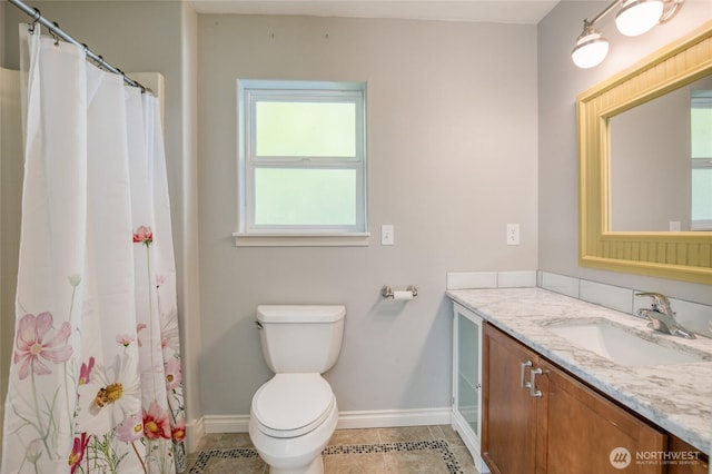 659 Chinook Ave SE, Ocean Shores, WA 98569 - full bathroom with vanity, baseboards, toilet, tile patterned flooring, and a shower with shower curtain