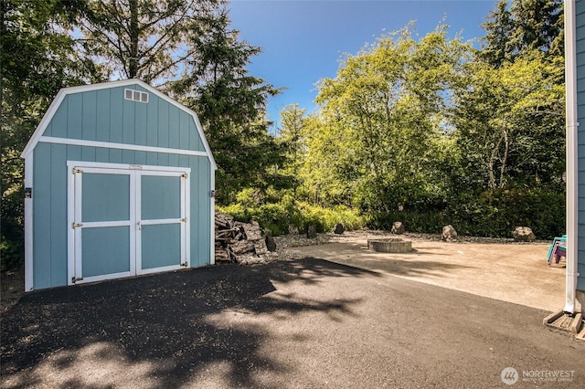 659 Chinook Ave SE, Ocean Shores, WA 98569 - view of shed with a fire pit