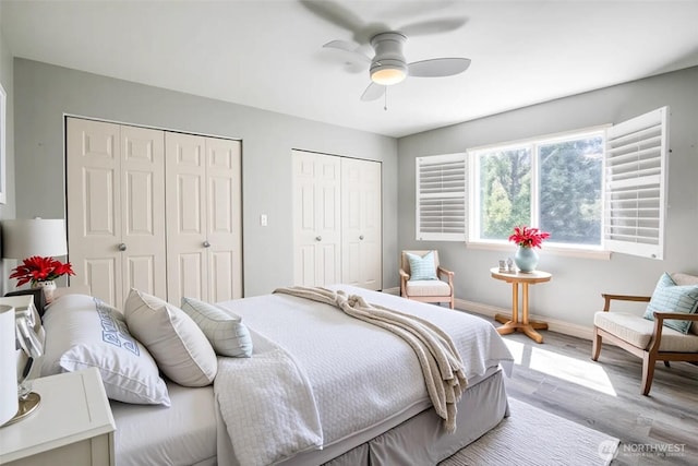659 Chinook Ave SE, Ocean Shores, WA 98569 - bedroom with multiple closets, wood finished floors, baseboards, and a ceiling fan