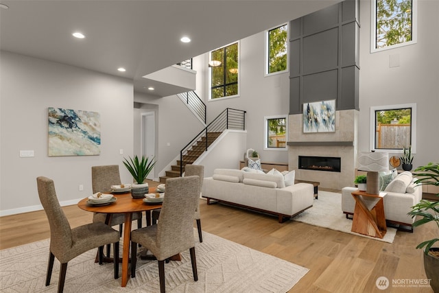 dining area with a wealth of natural light, light wood finished floors, and recessed lighting