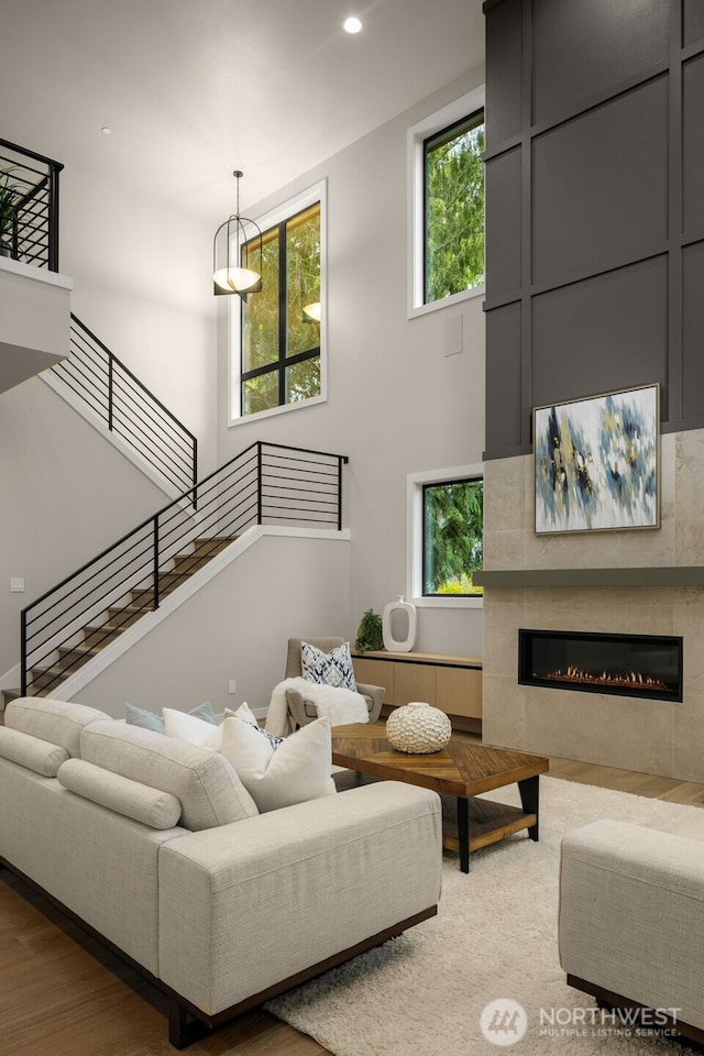 living room with a fireplace, recessed lighting, and plenty of natural light
