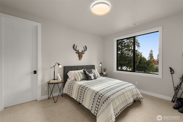 bedroom with baseboards, carpet flooring, and visible vents