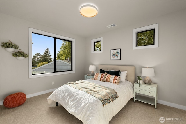 bedroom featuring baseboards, visible vents, and carpet floors
