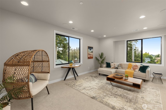 living area featuring carpet floors, baseboards, visible vents, and recessed lighting