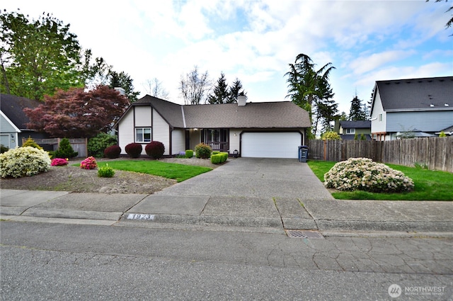 view of front facade featuring fence, roof with shingles, a garage, a chimney, and concrete driveway