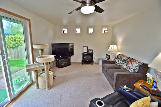 living area featuring carpet flooring and ceiling fan