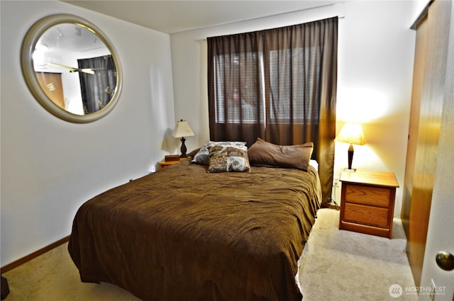 carpeted bedroom featuring baseboards