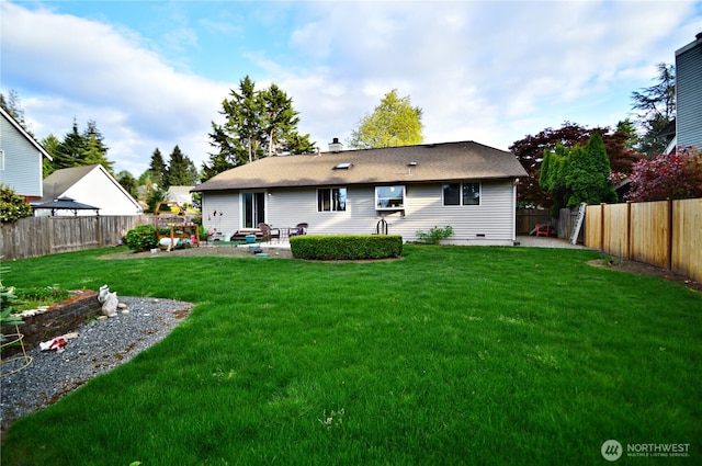 back of house with a fenced backyard, a patio area, a yard, and a chimney