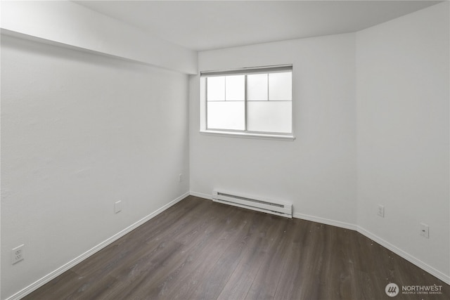 unfurnished room with baseboards, a baseboard heating unit, and wood finished floors