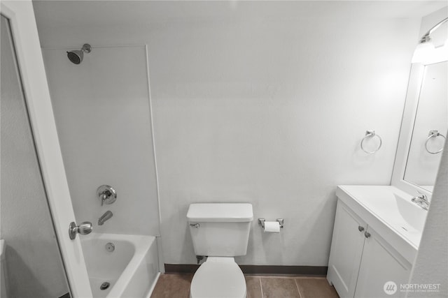 bathroom featuring vanity, baseboards, shower / bathtub combination, and toilet