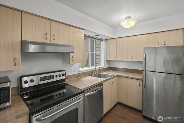 kitchen featuring light brown cabinetry, stainless steel appliances, and under cabinet range hood