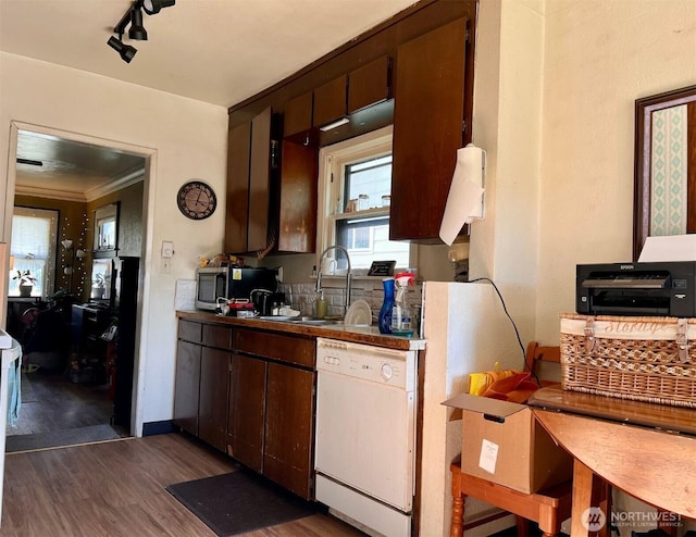 kitchen with ornamental molding, white dishwasher, stainless steel microwave, a sink, and dark wood finished floors