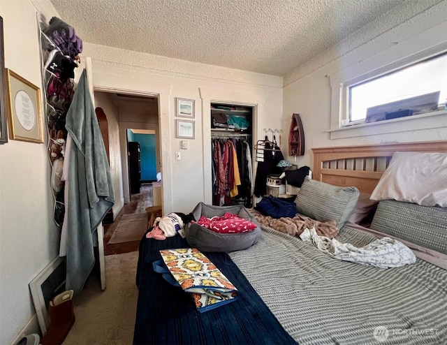 carpeted bedroom featuring a closet and a textured ceiling