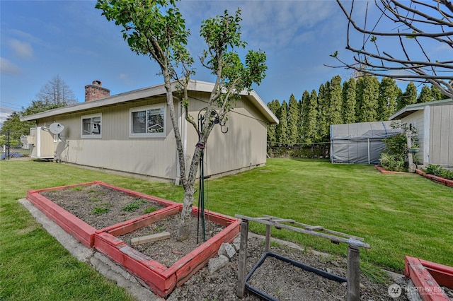 view of yard with fence and a vegetable garden