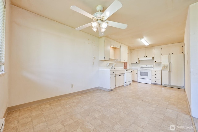 kitchen featuring white appliances, baseboards, light floors, light countertops, and a ceiling fan
