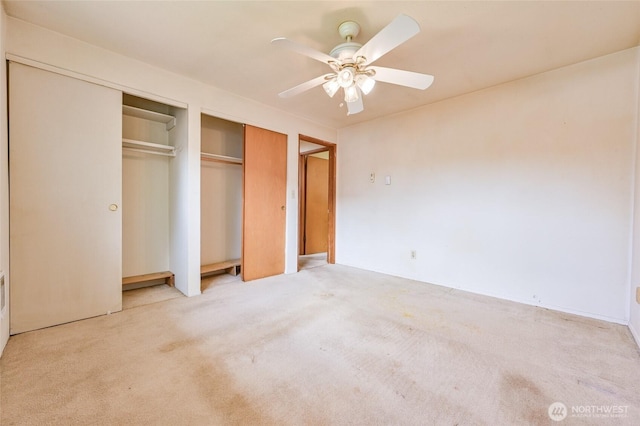 unfurnished bedroom featuring a closet, ceiling fan, and light carpet