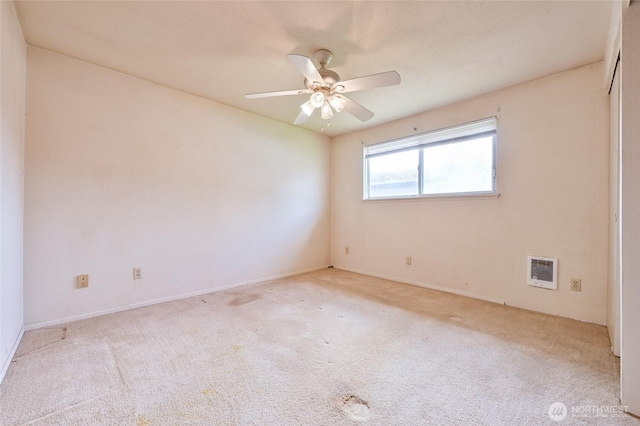 carpeted empty room with baseboards, a ceiling fan, and heating unit
