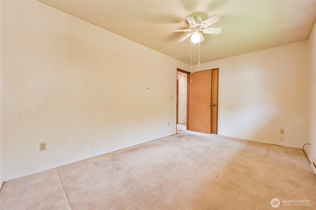 carpeted spare room with ceiling fan