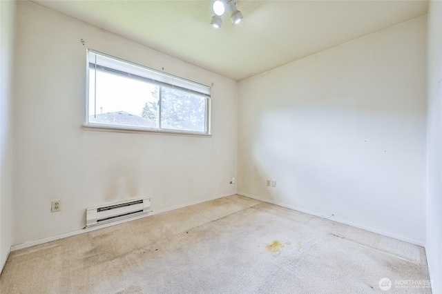 carpeted empty room with baseboards and a baseboard heating unit