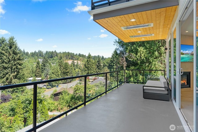 balcony featuring a view of trees