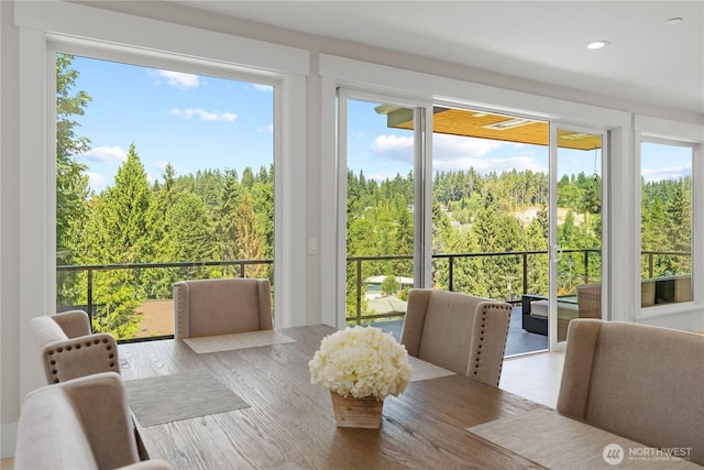sunroom / solarium featuring a wooded view