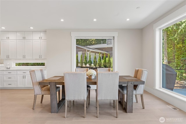 dining area featuring light wood-style flooring and recessed lighting