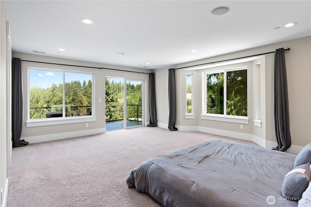 carpeted bedroom with access to outside, multiple windows, baseboards, and recessed lighting