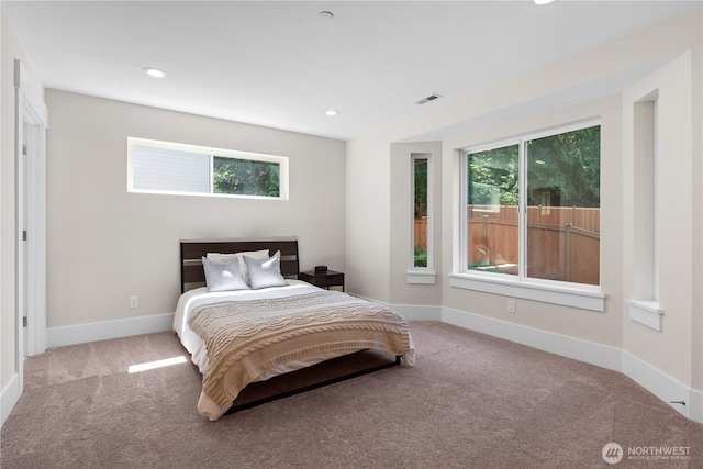 carpeted bedroom featuring recessed lighting and baseboards