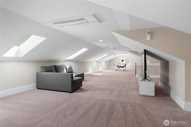 additional living space featuring a skylight, light carpet, lofted ceiling, and baseboards