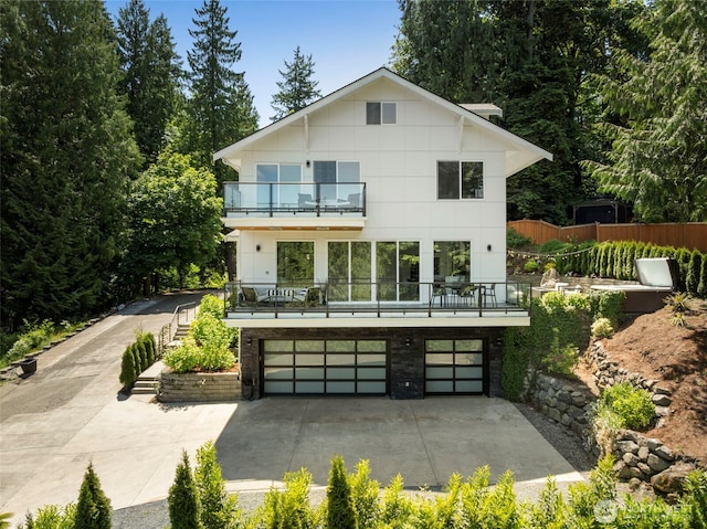 16831 84th Ln NE, Kenmore, WA 98028 - rear view of property with a balcony, an attached garage, and concrete driveway
