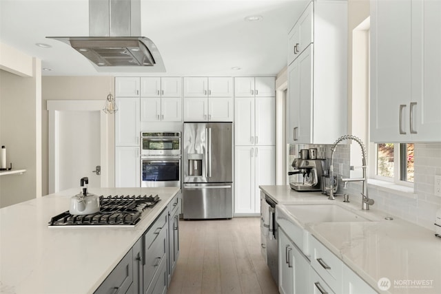 16831 84th Ln NE, Kenmore, WA 98028 - kitchen featuring stainless steel appliances, island range hood, a sink, decorative backsplash, and white cabinets