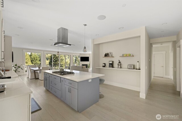 16831 84th Ln NE, Kenmore, WA 98028 - kitchen with gray cabinets, light wood-style floors, stainless steel gas stovetop, a sink, and recessed lighting