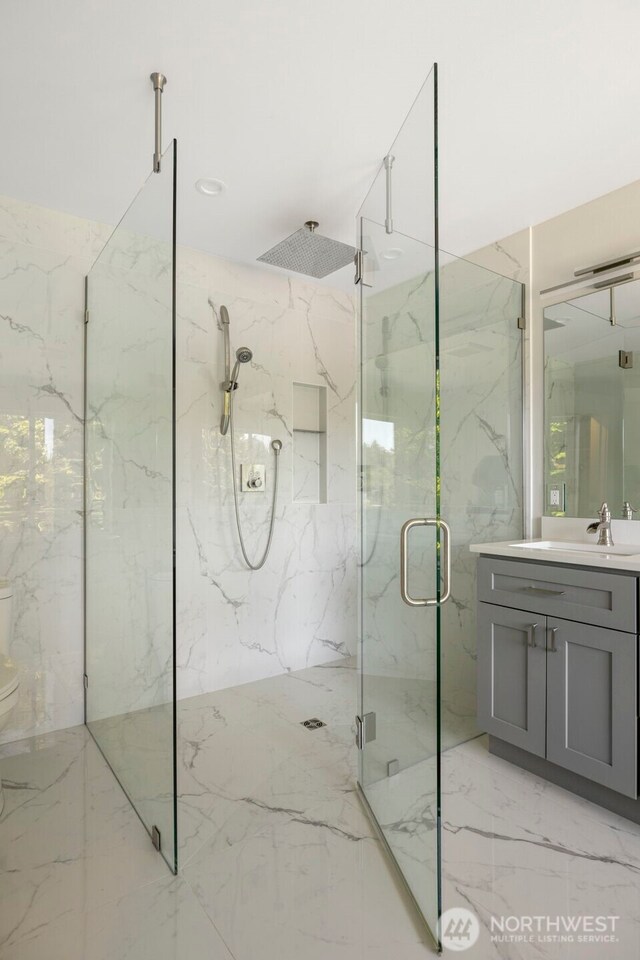 16831 84th Ln NE, Kenmore, WA 98028 - bathroom featuring a marble finish shower, vanity, toilet, and marble tiled flooring