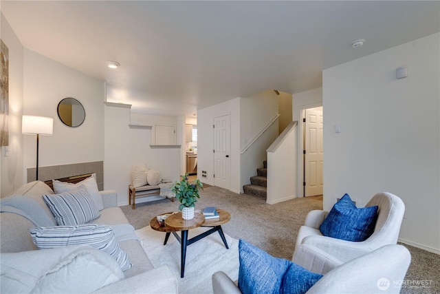living room featuring stairway, carpet floors, and baseboards